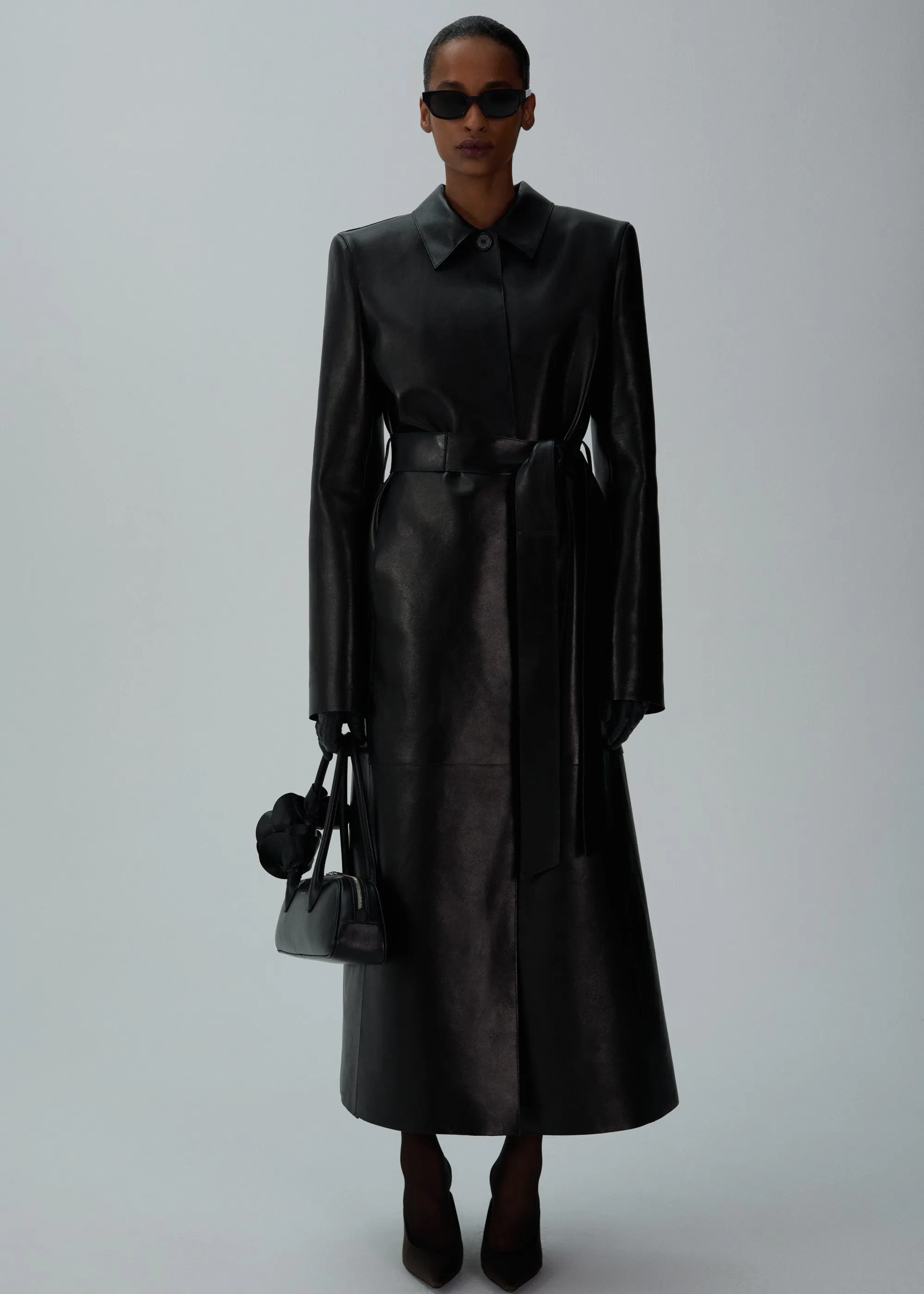 Belted leather coat in black